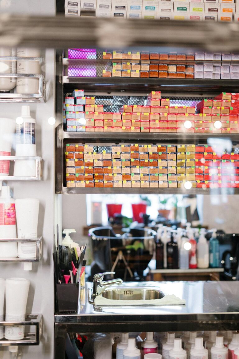 Neatly arranged hair salon products on shelves, showcasing vibrant colors and professional tools.